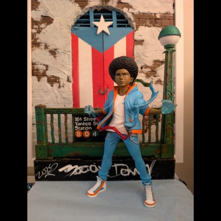 A figurine of a person in a blue outfit, standing in front of a Puerto Rican flag backdrop.
